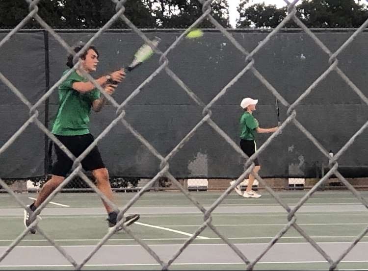 Sophomore Jett Lee returns a serve during a practice match.