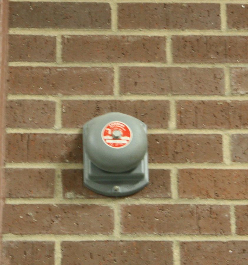 A picture of a bell within the school