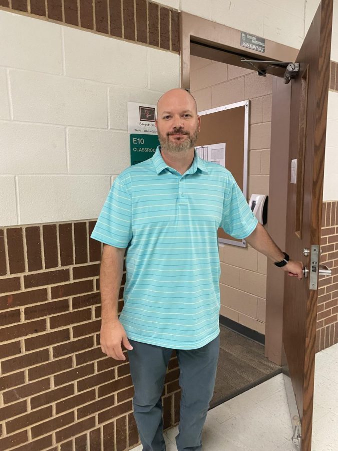 Coach Ball standing outside of his classroom.