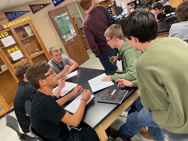 Coach Harrison works with students in his drone class.