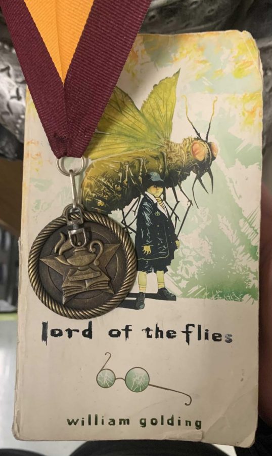 The Lord of the Flies book with a medal.