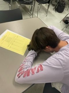 Senior Aaron Grow sleeping in class in front of his make-up hour sheet.