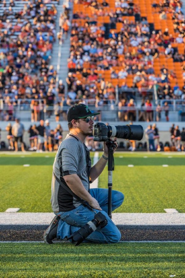 Richard Spragens taking photos at a football game