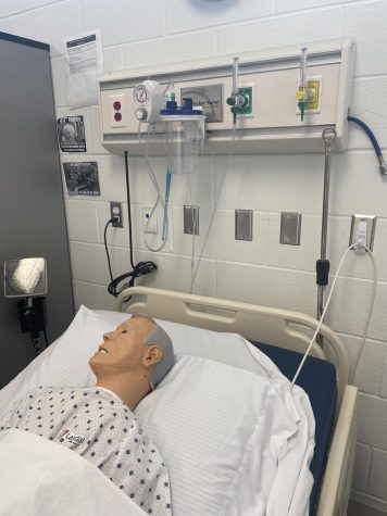Materials such as a mannequin, adjustable bed, and more are shown to help students in the Health Science Clinicals course learn CNA skills.