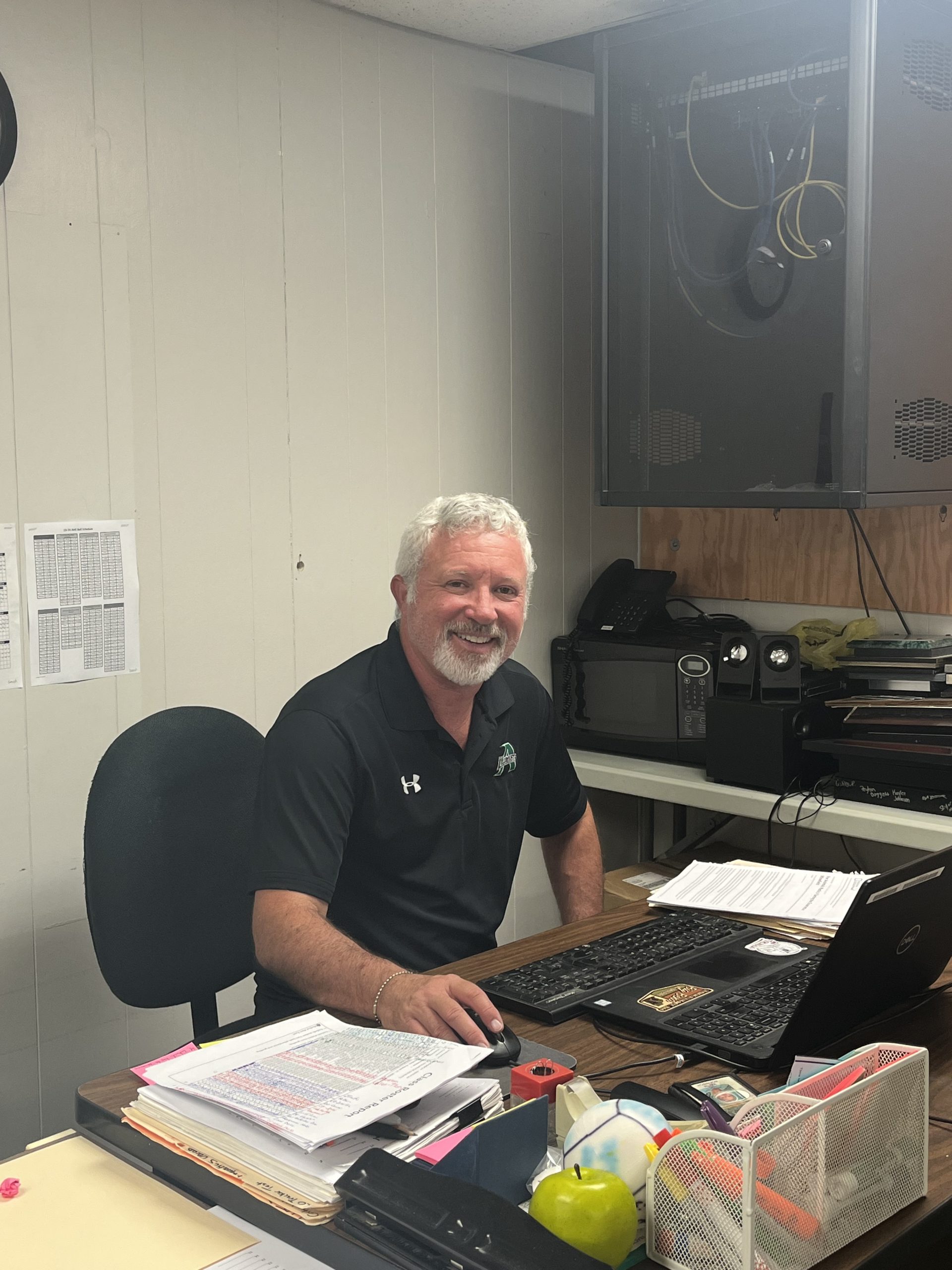 Coach Boenisch grading papers.