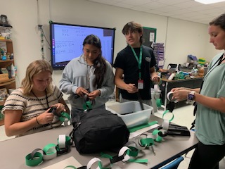 Student Council members Lance Smith, Emily Smith, Story Hilliard, and Miranda Sanchezi make decorations for the school halls. 