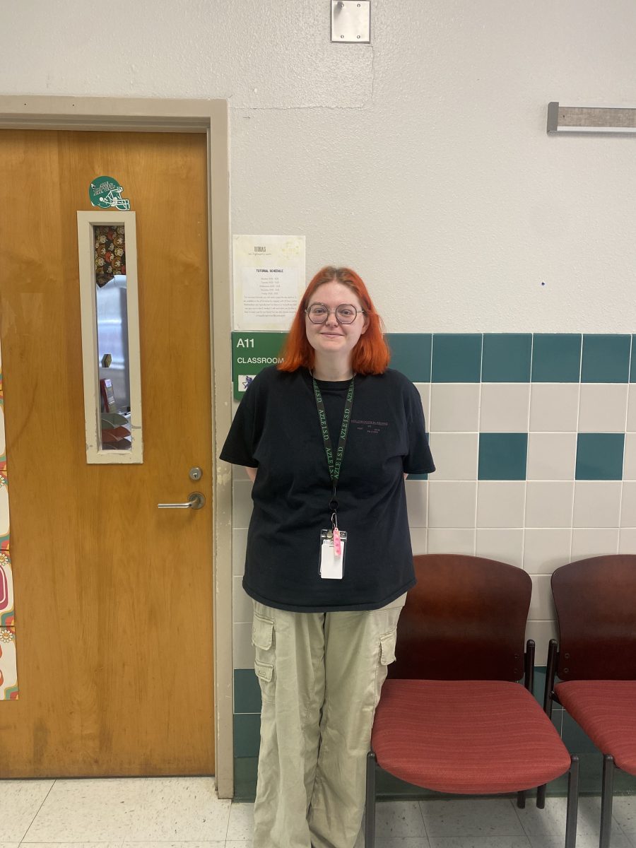 English teacher, Kassidy Hightower standing outside her classroom in A11.