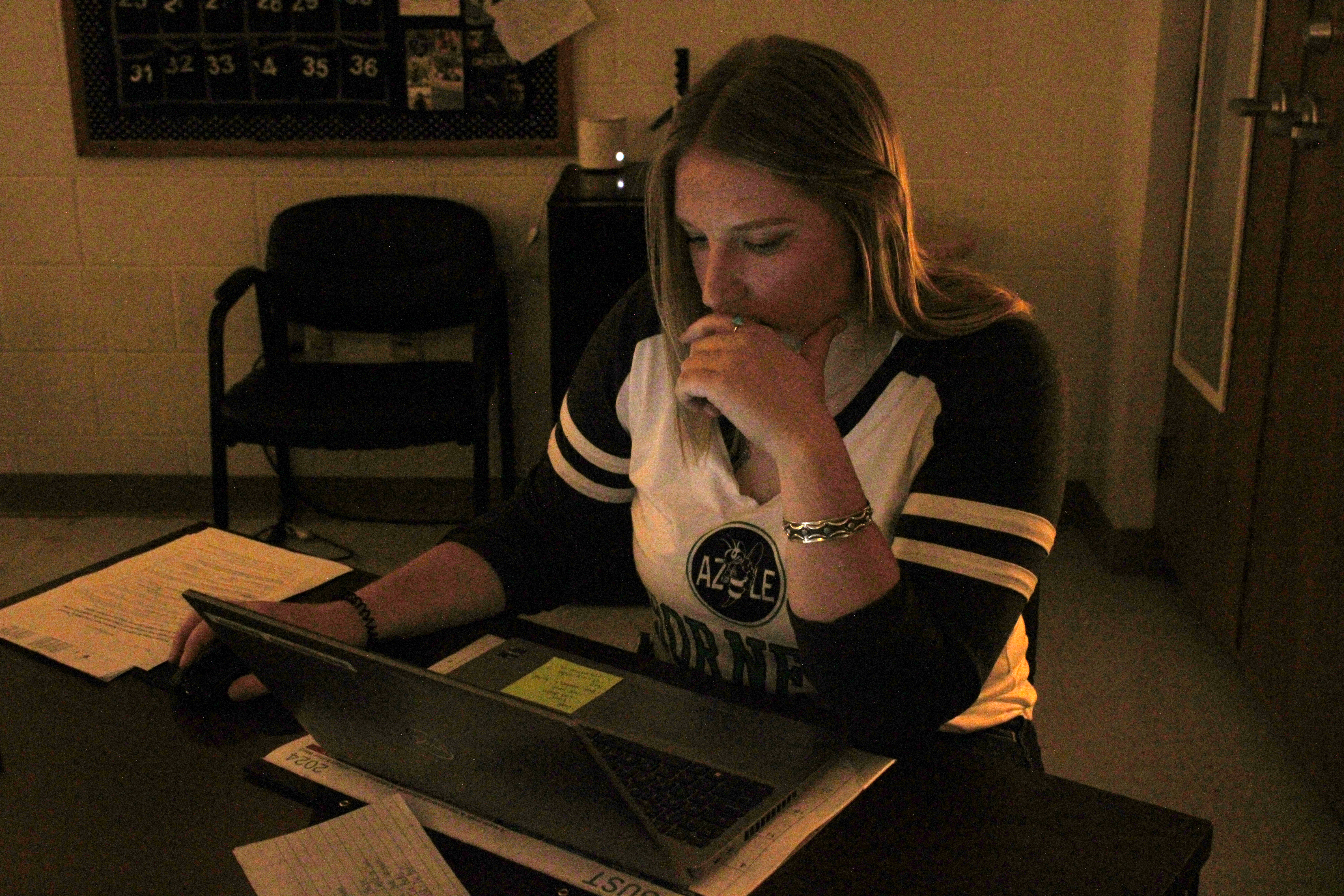 Amanda Seymour (English II Teacher) works on her computer at her desk during class.