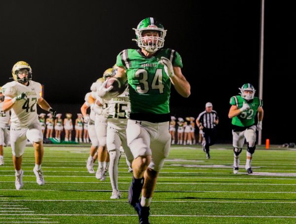 Hagen runs the ball toward the endzone.