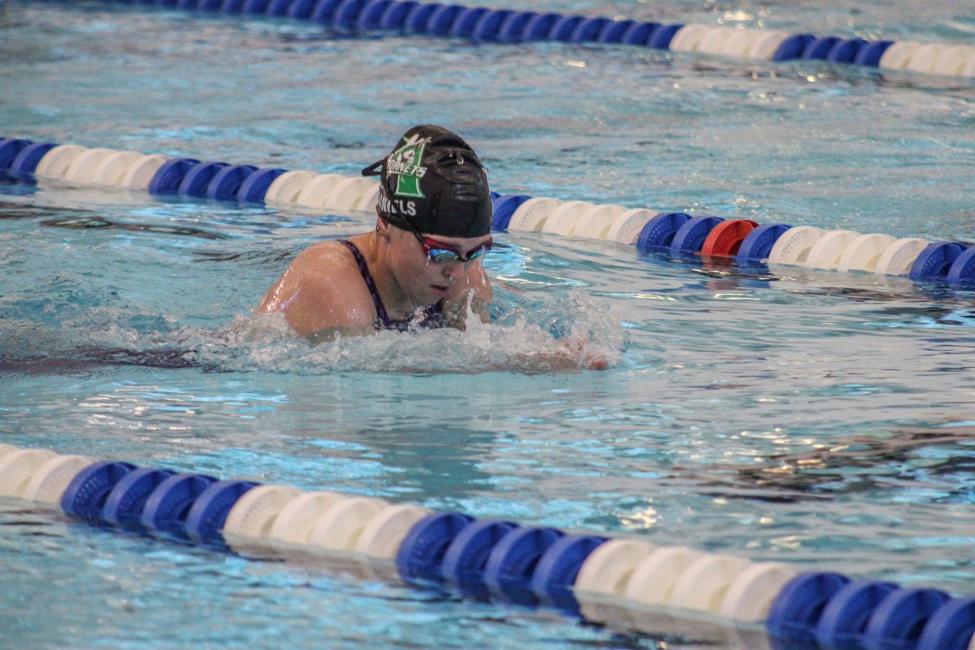 Senior Kaylee Daniels swims during the District meet.