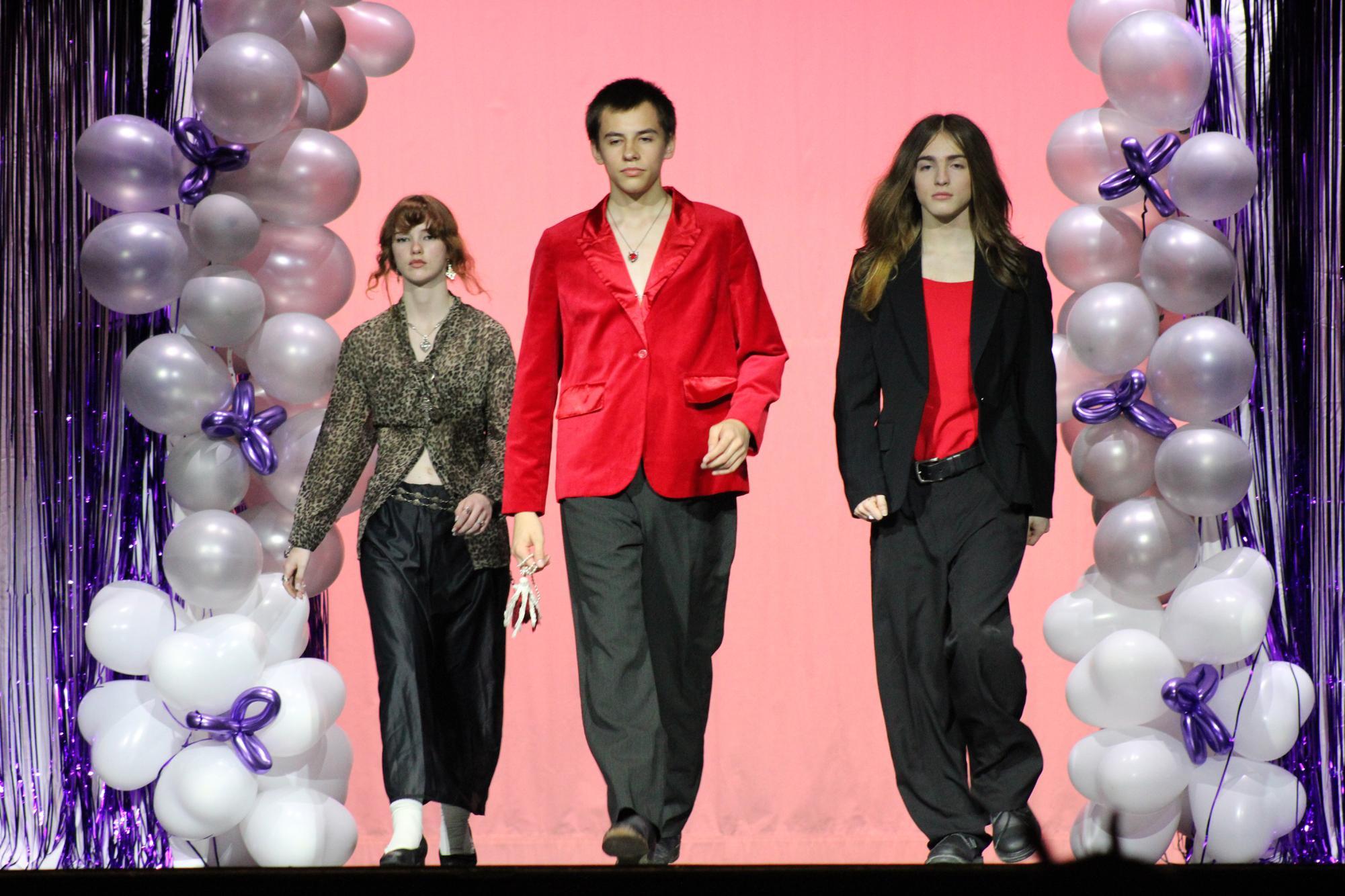 Freshman Madison Monagle, sophomore Joshua Click and senior Rylan Baker walk down the runway.