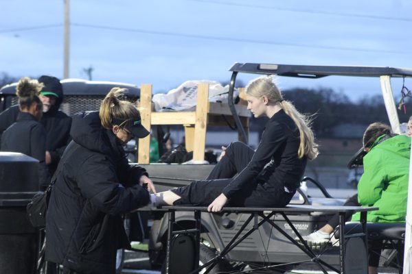 Athletic trainer Christine Hardee helps sophomore Nicole Johnson at a track meet.