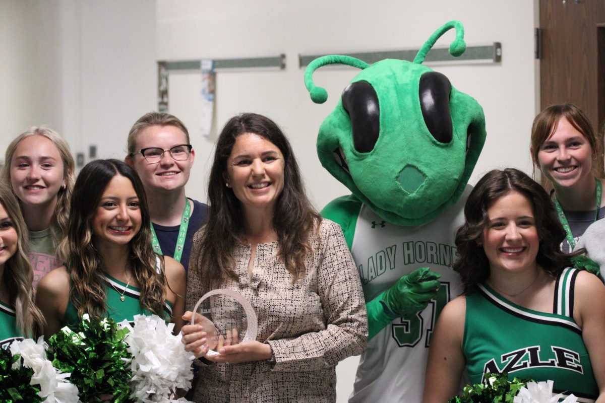 Mrs. Bevan posing with her Teacher of The Year award.