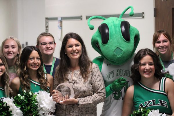 Mrs. Bevan posing with her Teacher of The Year award.