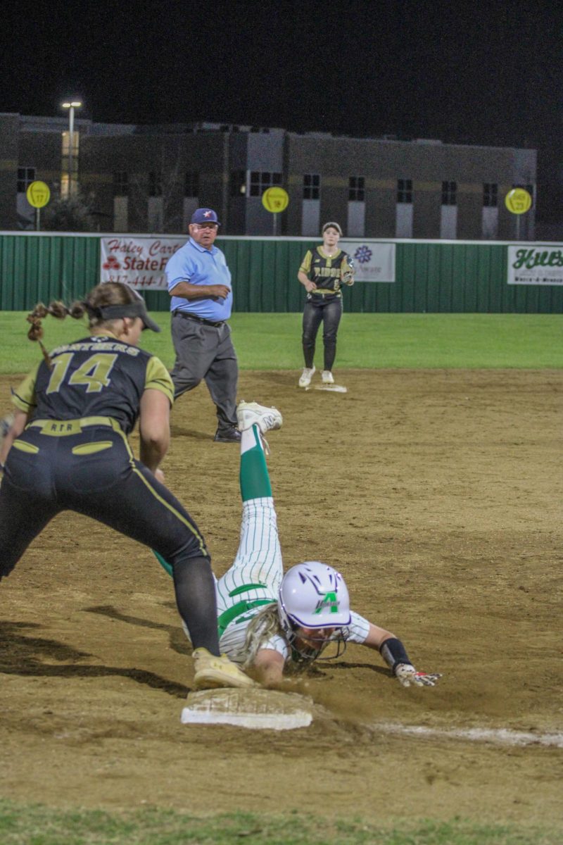 Junior Ema Lehr slides for third.
