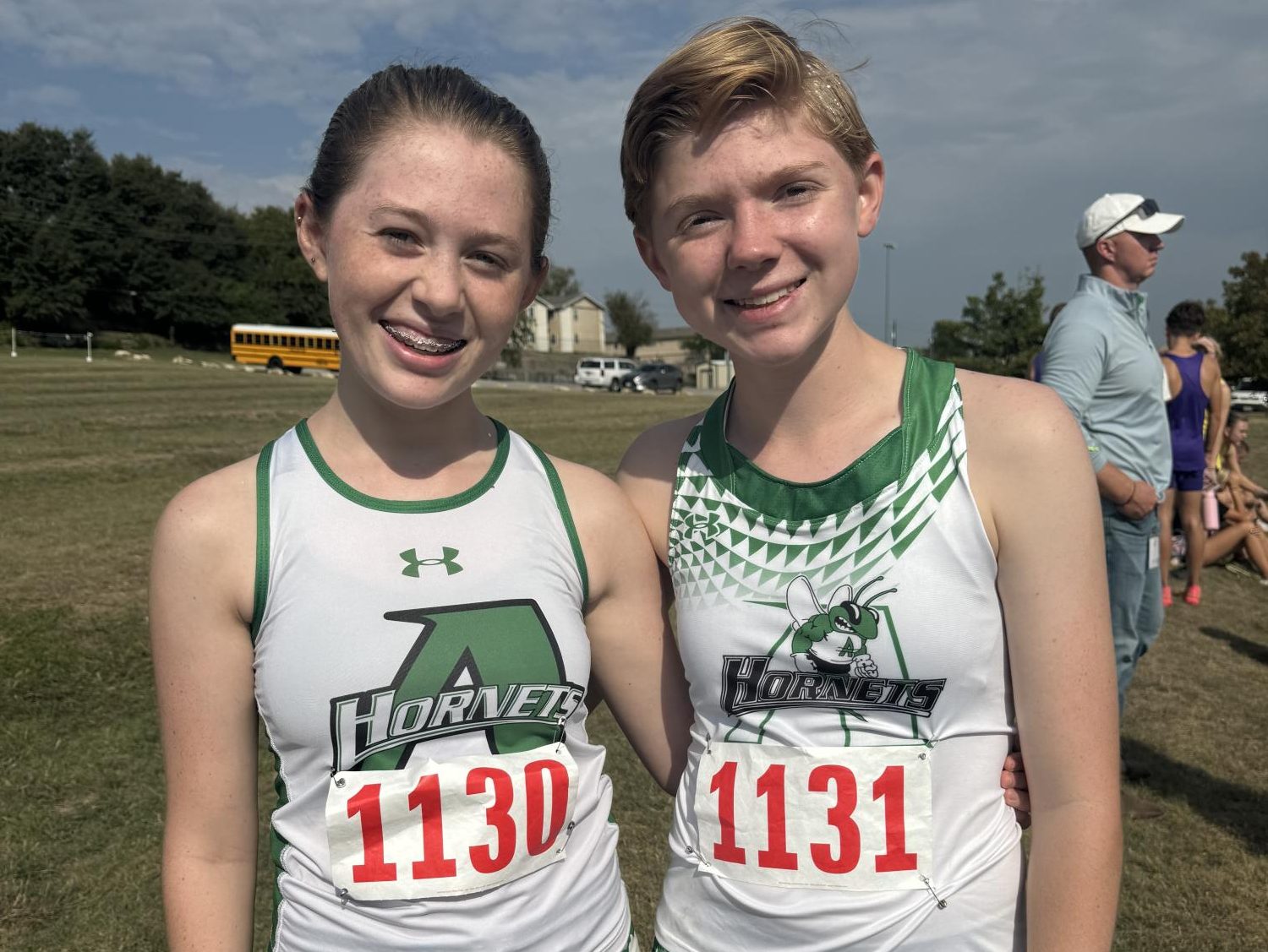 Juniors Eliana and Lily Hudman pose at a cross-country meet.