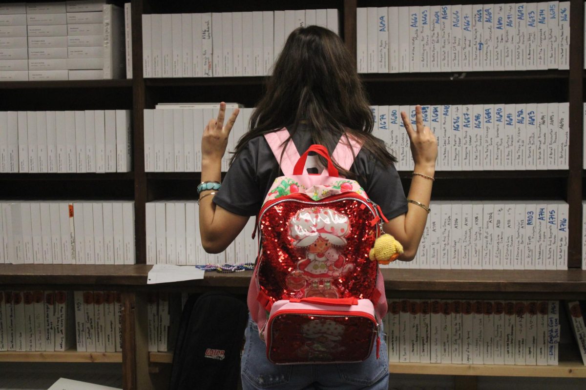 Senior Lila Harden shows off her Strawberry Shortcake Backpack.