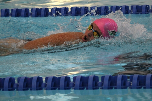 Senior Kayley Brekel wears her lucky pink swim cap for her first 200 race of the year at Northwest ISD Natatorium. Photo curiosity of Dakota Donaldson.