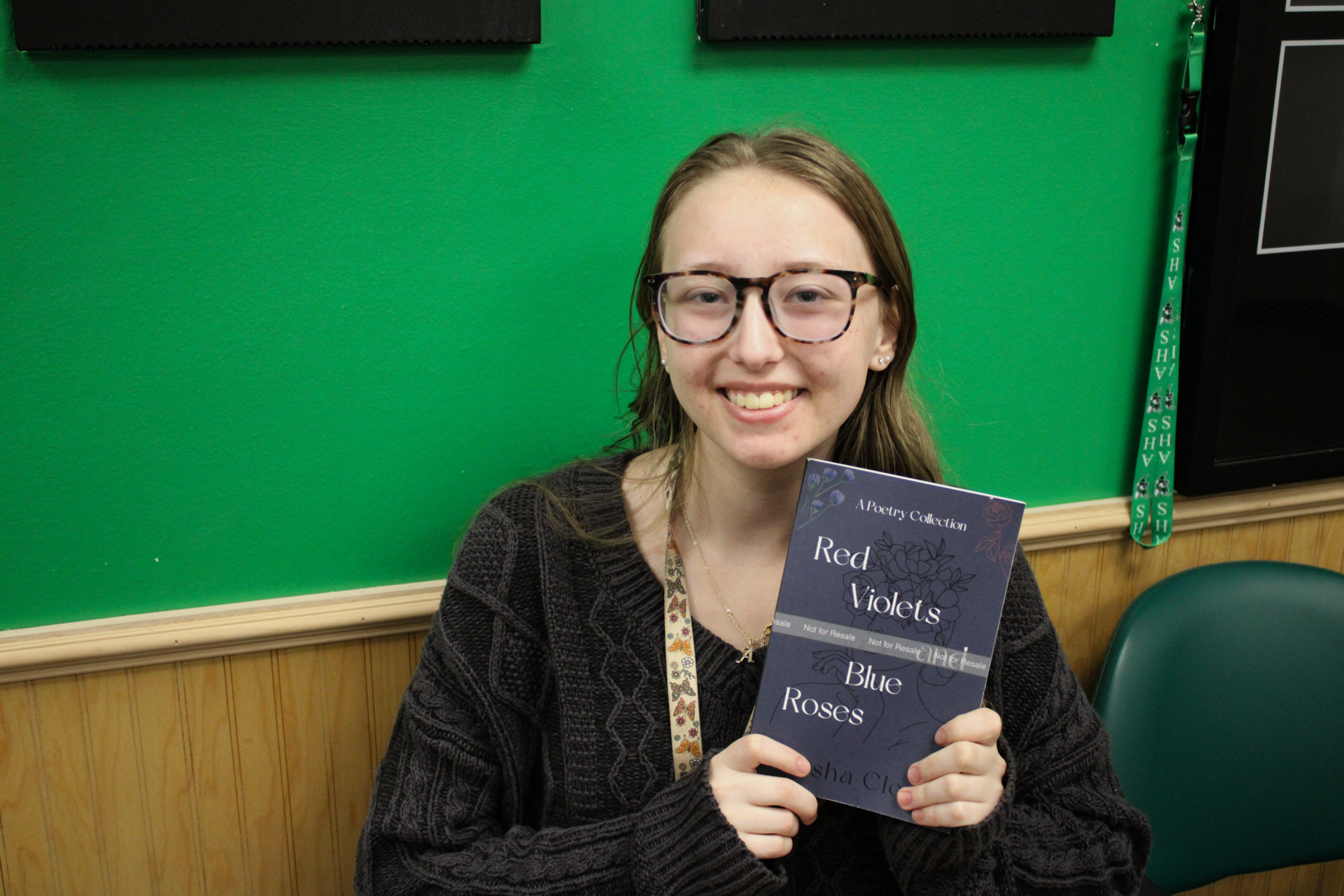 Senior Porsha Clontz Reps a copy of her self-published poetry collection, "Red Violets and Blue Roses."