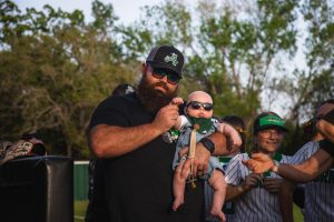 Coach Moorman with his son, Marshall, at a softball game.